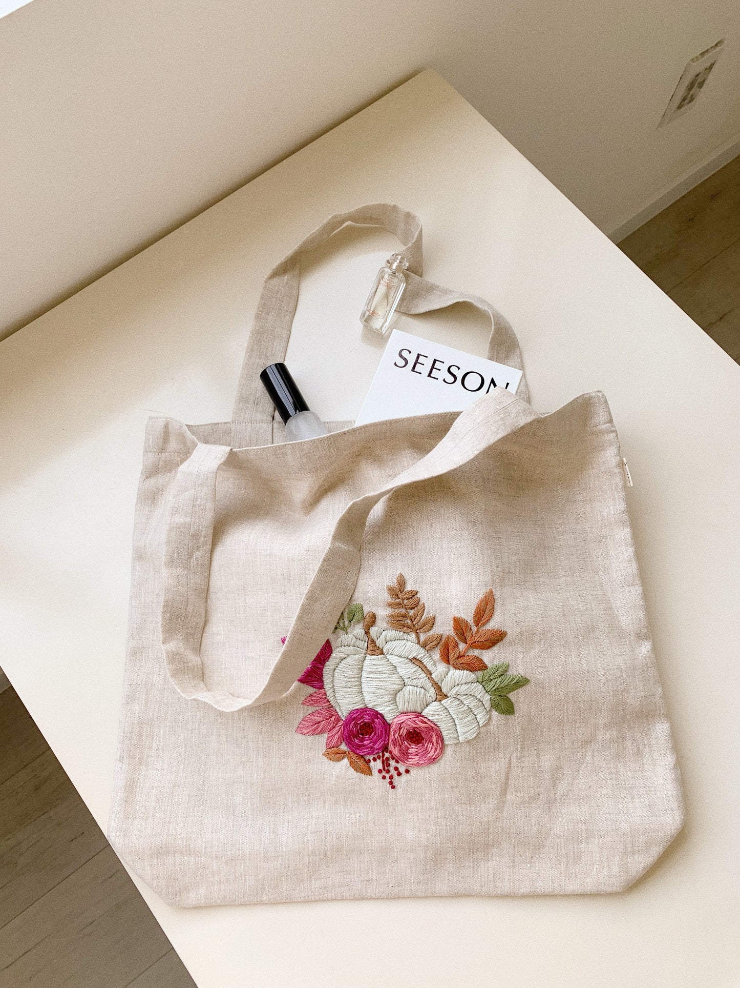 Hand embroidered linen tote bag with pumpkin design
