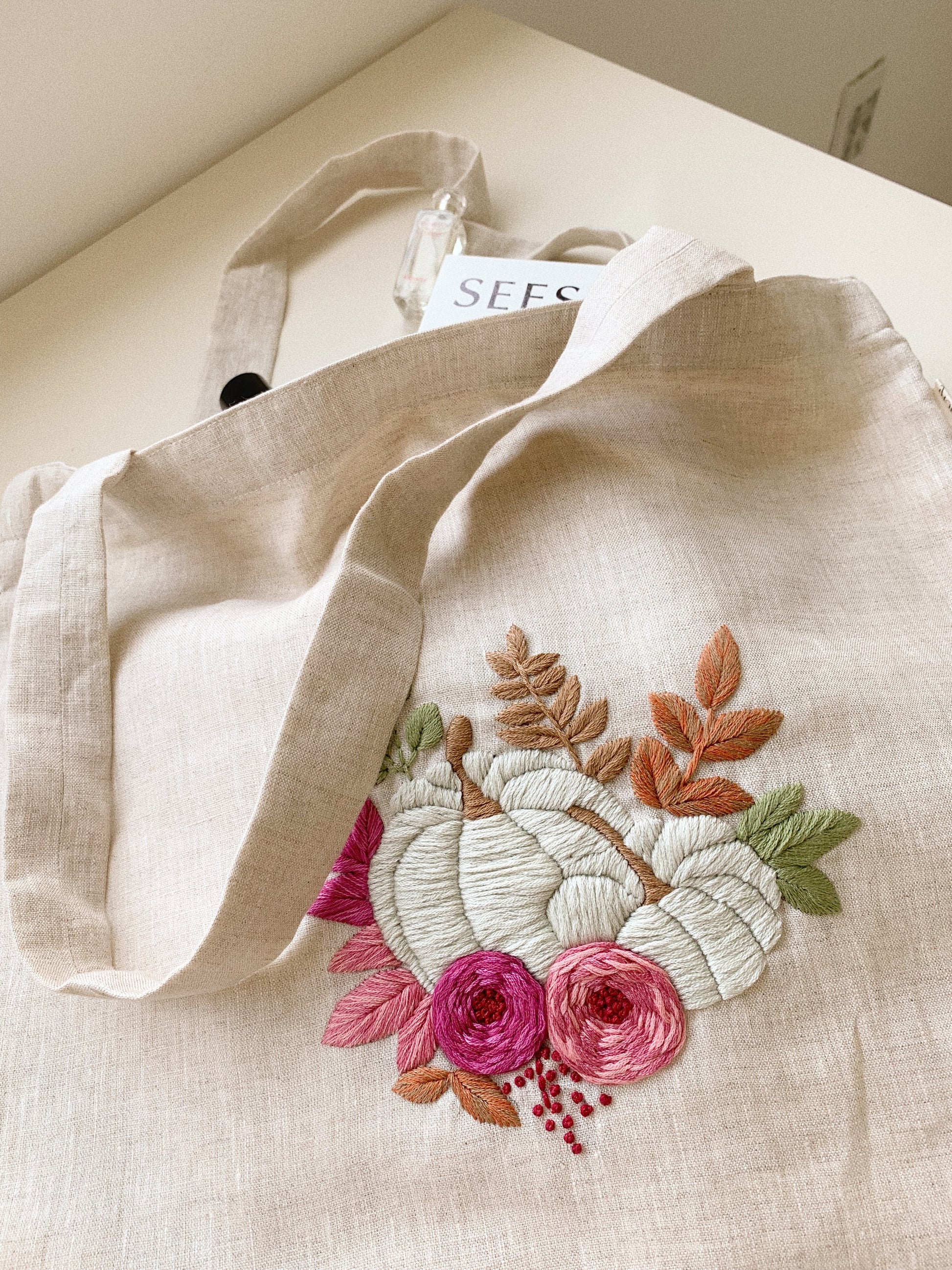 Hand embroidered linen tote bag with pumpkin design